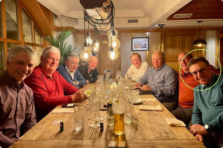 group of men sitting at a table in a restaurant