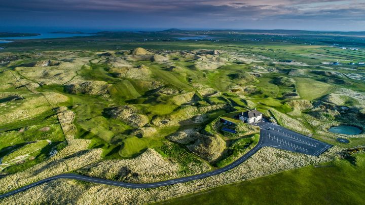 aerial shot of carne golf links with clubhouse and seaview